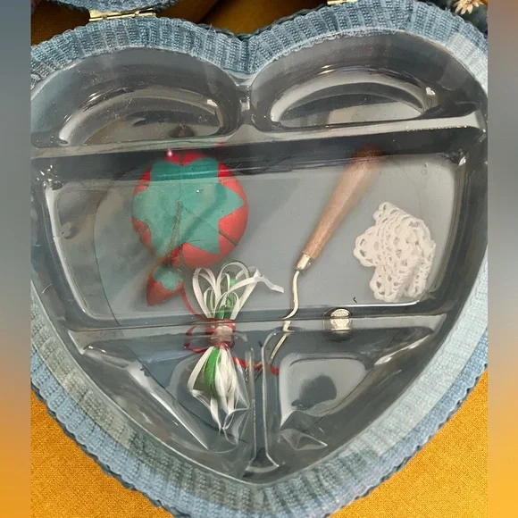 Vintage like new floral heart shaped sewing box. Comes with some sewing tools.